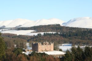 Drumlanrig Castle in the snowy Scottish hills
